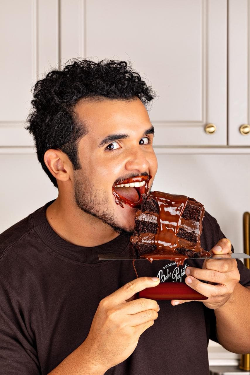 Igor provando uma fatia de bolo de chocolate